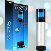 The Blush Novelties Performance VX10 Smart Penis Pump - Clear is displayed beside its packaging. The cylindrical pump has a digital display on top, measurement markings along the side, and the box highlights its key features and specs.